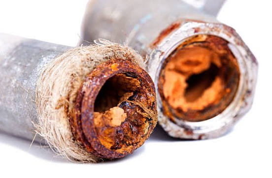 rust and scale buildup inside old water pipes